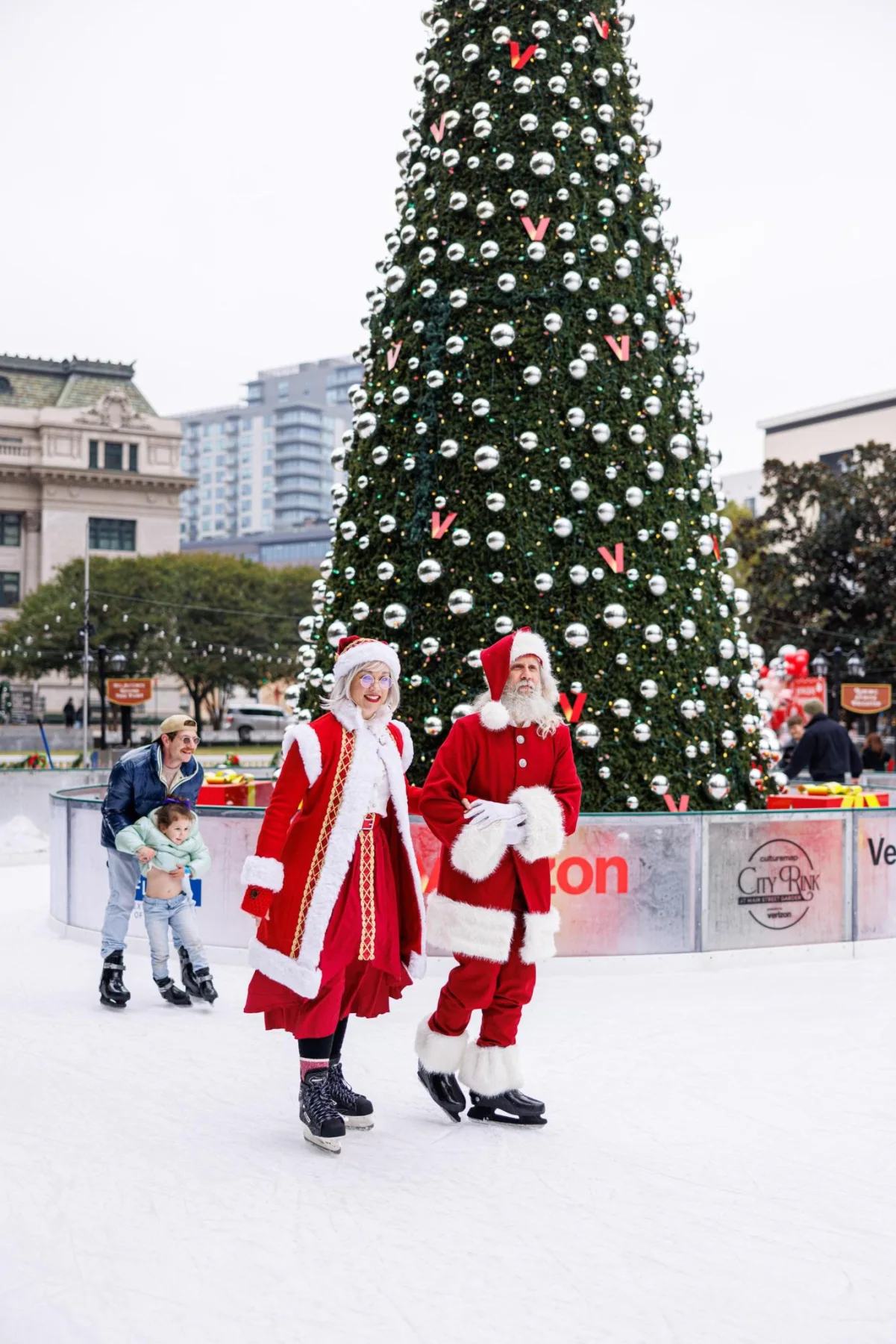 Santa and Mrs. Claus skating in front of the City Rink Christmas tree